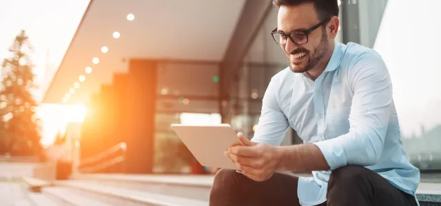 Businessman in glasses holding tablet